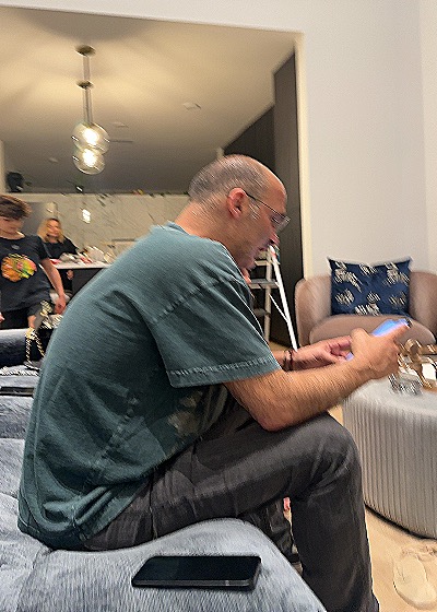 Photo of man sitting on couch using phone 2023 — front
