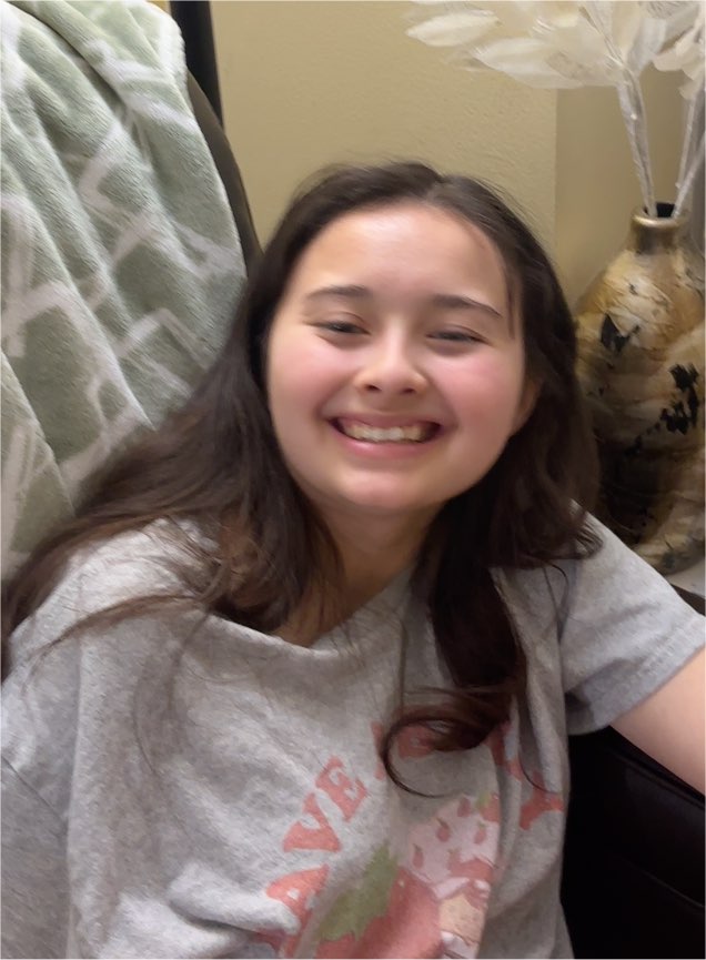 Photo of young girl smiling — front