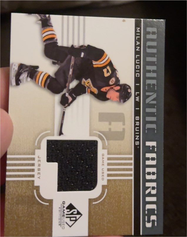 2011-12 Upper Deck SP Game Used Authentic Fabrics #AF-ML Milan Lucic — front