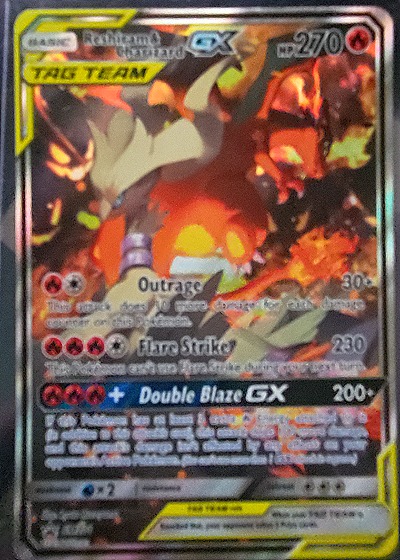 2019 Pokémon TCG SM Black Star Promo #SM201 Reshiram & Charizard GX — front