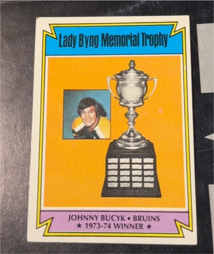 1974-75 Topps #245 Johnny Bucyk Lady Byng Memorial Trophy — front