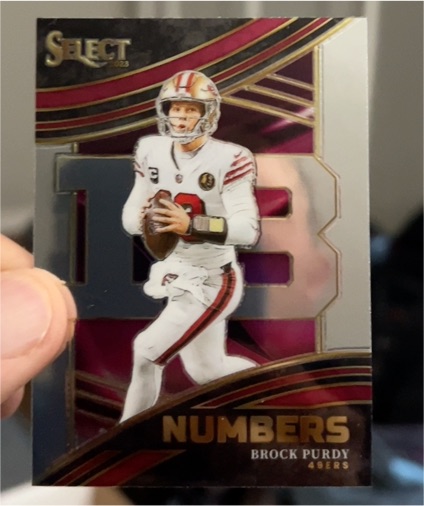 2023 Panini Select - Select Numbers #NMB-BPU Brock Purdy — front