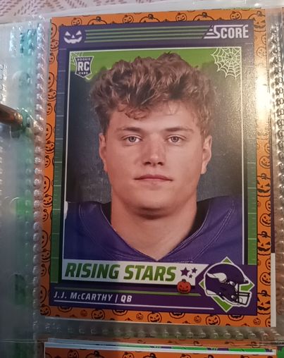 2024 Panini Score-A-Treat #19 J.J. McCarthy Rising Stars Orange Pumpkins Rookie Card — front