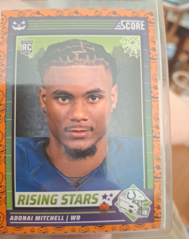 2024 Panini Score-A-Treat #1 Adonai Mitchell Rising Stars Orange Pumpkin Rookie Card — front