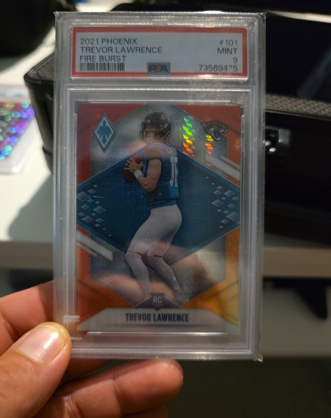 2021 Panini Phoenix #101 Trevor Lawrence Fire Burst Rookie Card — front