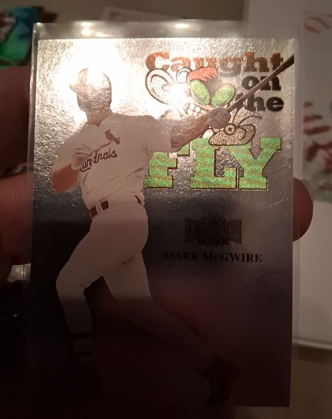 1999 Skybox Metal Universe #244 Mark McGwire Caught on the Fly — front