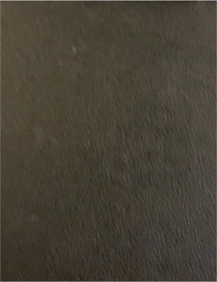 Black textured surface item — front