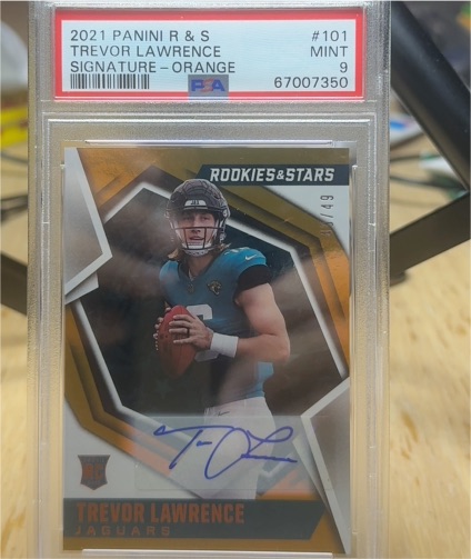 2021 Panini Rookies & Stars #101 Trevor Lawrence Signature - Orange — front