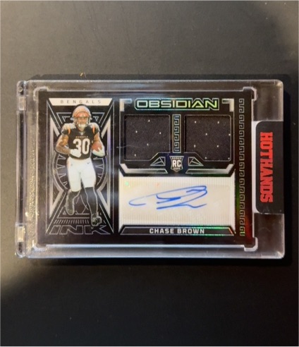 2023 Panini Obsidian #RJI-CBR Chase Brown Rookie Jersey Ink Dual Patch Auto — front