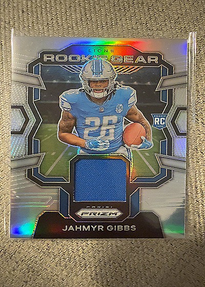 2023 Panini Prizm Rookie Gear #RG-JG Jahmyr Gibbs — front