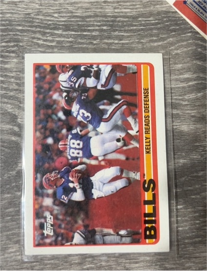 1989 Topps #40a Bills Team Leaders (Kelly Reads Defense) Jim Kelly — front