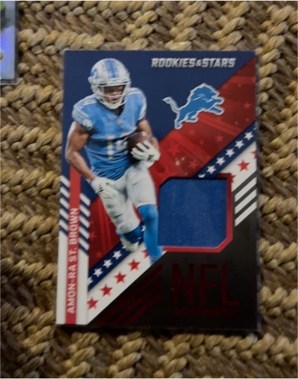 2022 Panini Rookies & Stars NFL Authentic #NA-ASB Amon-Ra St. Brown — front