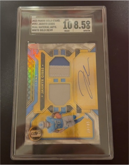 2023 Panini Gold Standard #251 Jahmyr Gibbs Dual Material Auto White Gold 28/49 — front
