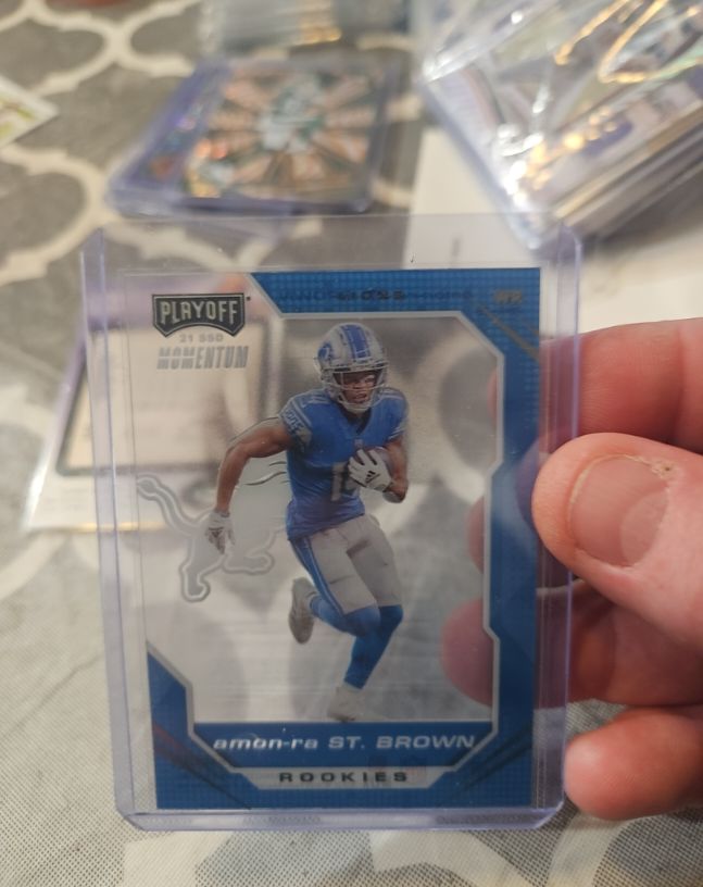 2021 Panini Chronicles Playoff Momentum #PMR-28 Amon-Ra St. Brown — front