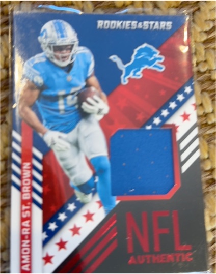 2022 Panini Rookies & Stars NFL Authentic #NA-ASB Amon-Ra St. Brown — front