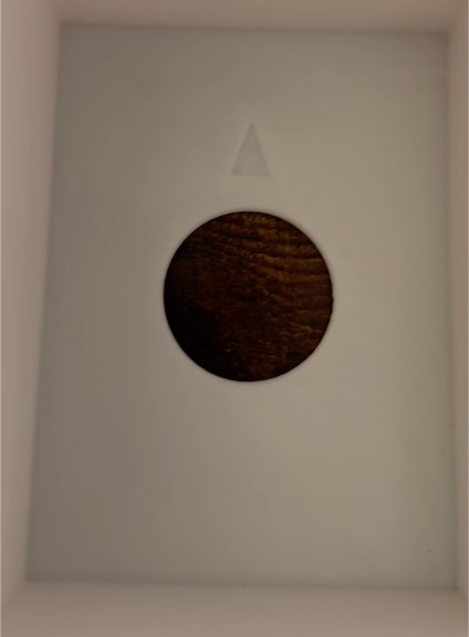 Triangle-shaped brown wooden insert — front