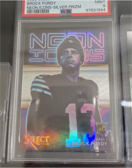 2022 Panini Select Neon Icons #NI-15 Brock Purdy Silver Prizm Rookie — front
