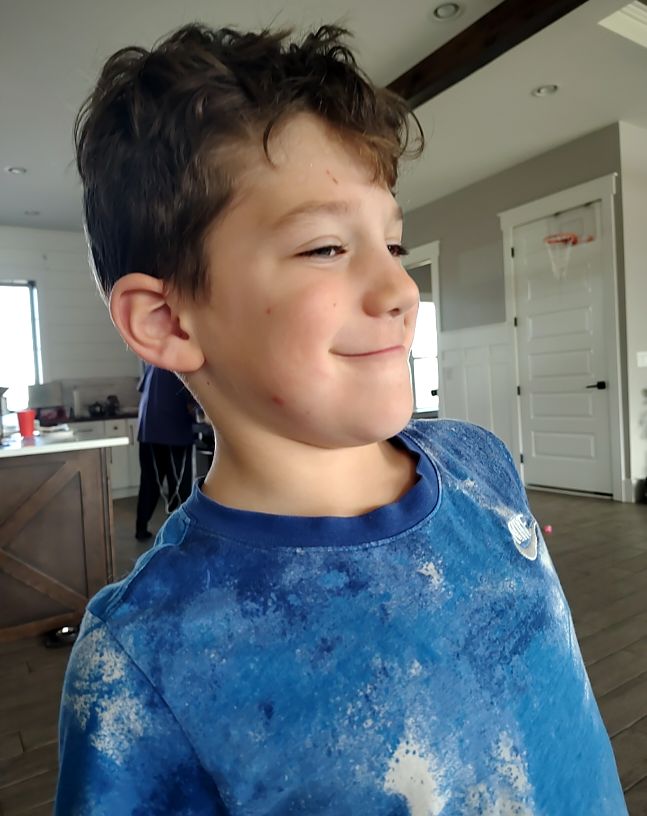 Photo of young boy in blue shirt — front