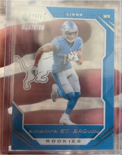 2021 Panini Chronicles Playoff Momentum Rookies #PMR-28 Amon-Ra St. Brown — front