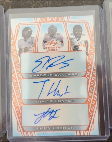2024 Leaf Trinity SP #/49 Shedeur Sanders Travis Hunter Jimmy Horn Jr. Triple Auto Rookie — front