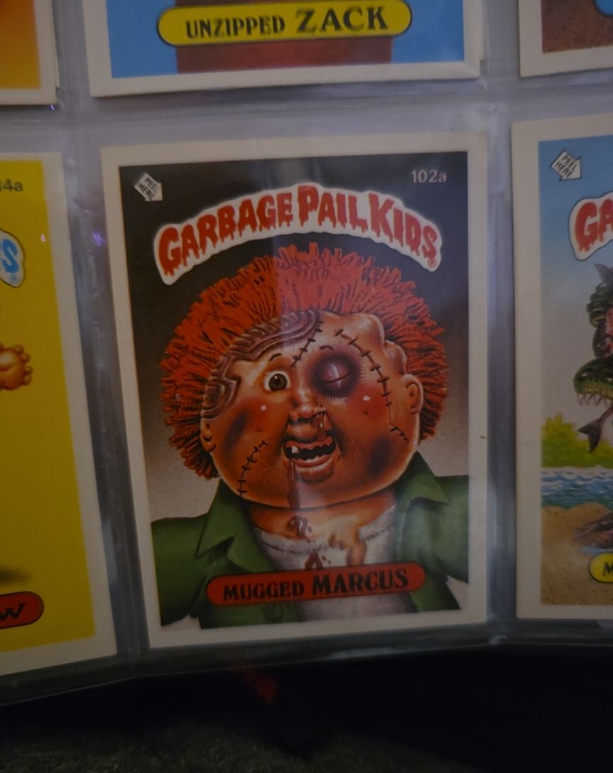 1986 Topps Garbage Pail Kids #102a Mugged Marcus — front