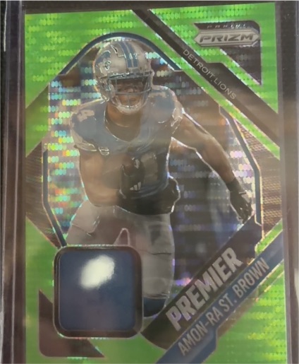 2025 Panini Prizm #PJY-ASB Amon-Ra St. Brown Premier Jerseys Neon Green Pulsar — front