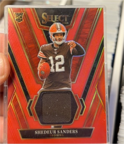 2025 Panini Select #RSW-SSS Shedeur Sanders Rookie Swatches Red Prizm — front
