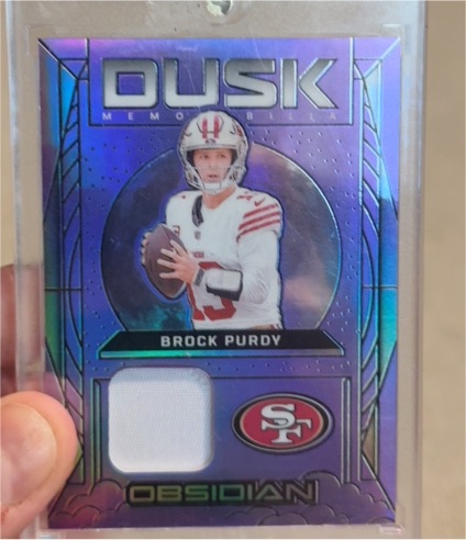 2024 Panini Obsidian Dusk Memorabilia #DM-BPY Brock Purdy — front
