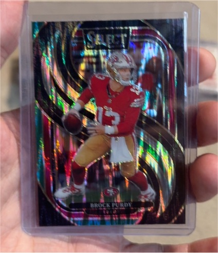 2024 Panini Select #124 Brock Purdy Premier Level Black & Red Prizm Shock — front
