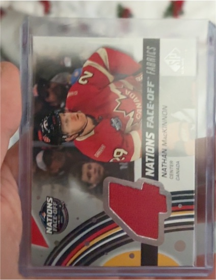 2025-26 Upper Deck SP Game Used #4N-MA Nathan MacKinnon 4 Nations Face-Off Fabrics — front