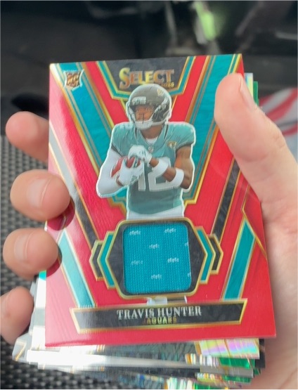 2025 Panini Select #RSW-THR Travis Hunter Rookie Swatches Red Prizm — front