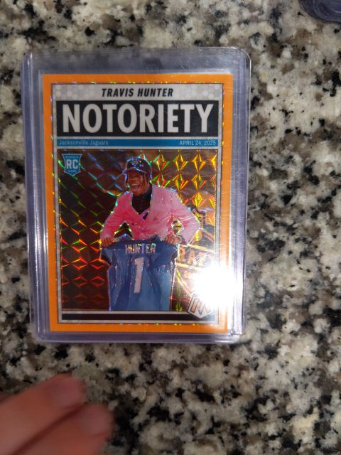 2025 Panini Mosaic #12 Travis Hunter Notoriety Orange Fluorescent Mosaic Prizm Rookie — front