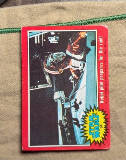 1977 Topps Star Wars #84 Rebel pilot prepares for the raid — front