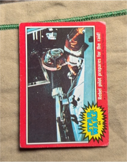 1977 Topps Star Wars #84 Rebel pilot prepares for the raid — front