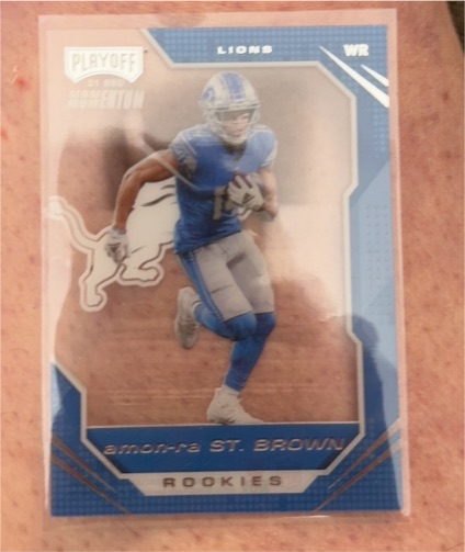 2021 Panini Chronicles Playoff Momentum #PMR-28 Amon-Ra St. Brown Rookie — front