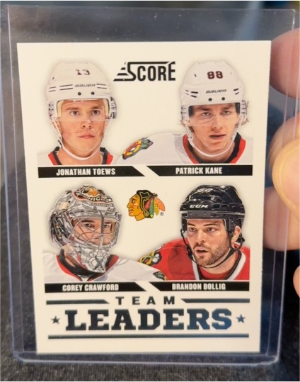 2013-14 Panini Score #556 Jonathan Toews Patrick Kane Corey Crawford Brandon Bollig — front