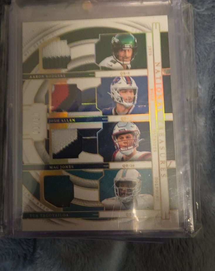 2023 Panini National Treasures NFL Gear Quad Materials #GQM-QB3 Aaron Rodgers, Josh Allen, Mac Jones, Tua Tagovailoa — front